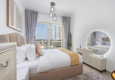 a bedroom with a large bed and a large window at Dubai Marina-short stay in Dubai