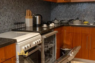 a kitchen with a stove and some pots and pans at Central Park towers Difc Royal suite kings in Dubai