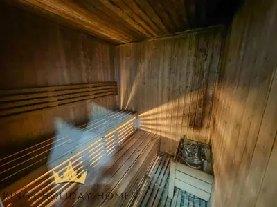 an empty wooden sauna with a person in it at Central Park towers Difc Royal suite kings in Dubai