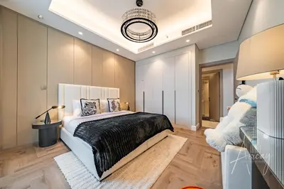 a bedroom with a large bed with a black blanket at Stylish 2BRUrban Retreat 10 Min to Burj Khalifa in Dubai