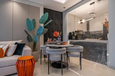 a living room with a couch and a table with chairs at Stylish 2BRUrban Retreat 10 Min to Burj Khalifa in Dubai