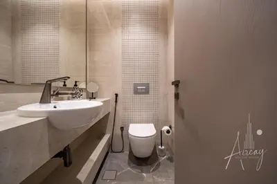 a bathroom with a white sink and a toilet at Stylish 2BRUrban Retreat 10 Min to Burj Khalifa in Dubai