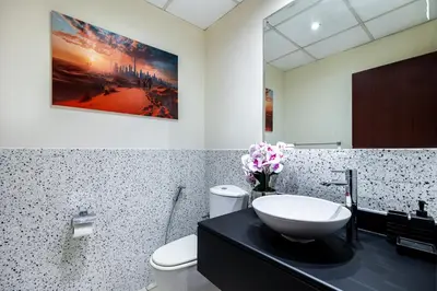 a bathroom with a sink and a toilet at Dubai Eye and Sunset Views 1 Bedroom Apartment with Direct Beach Access, Gym, and Pool in Dubai