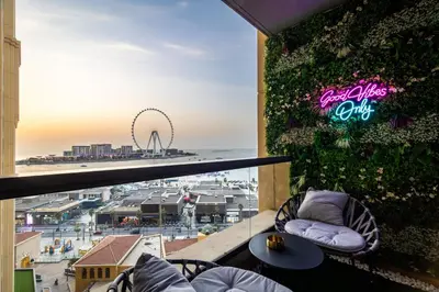 a balcony with a view of a city at Dubai Eye and Sunset Views 1 Bedroom Apartment with Direct Beach Access, Gym, and Pool in Dubai