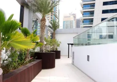 a balcony with palm trees and a glass walkway at Well located Studio on 9 floor Sky View Tower in Dubai