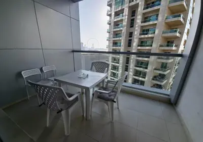 a table and chairs in a room with a window at Well located Studio on 9 floor Sky View Tower in Dubai
