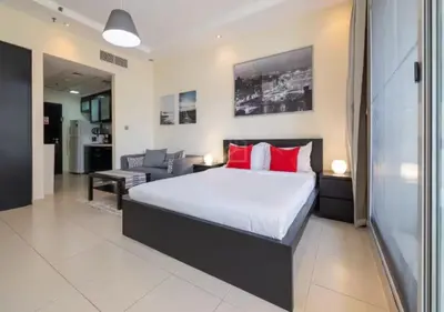 a bedroom with a large bed with red pillows at Well located Studio on 9 floor Sky View Tower in Dubai