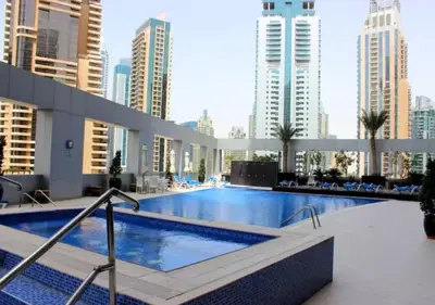 a large swimming pool in a building with tall buildings at Well located Studio on 9 floor Sky View Tower in Dubai