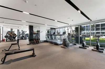 a gym with a lot of treadmills and machines at Amazing 1BR Apt in Business Bay - Nobles Tower - Close to Dubai Mall in Dubai