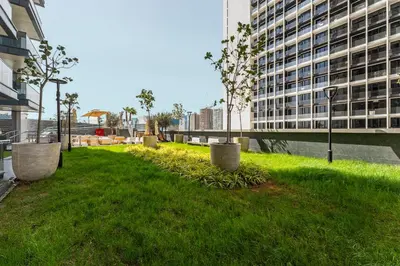 a grassy area with trees in the middle of a building at Amazing 1BR Apt in Business Bay - Nobles Tower - Close to Dubai Mall in Dubai