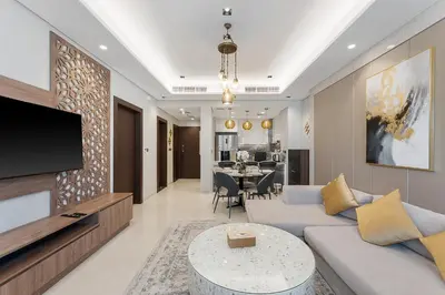 a living room with a couch and a tv at Amazing 1BR Apt in Business Bay - Nobles Tower - Close to Dubai Mall in Dubai