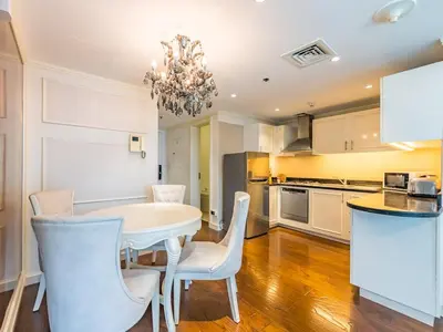 a dining room with a white table and chairs at Luxury Spacious Condo in the Iconic Park Towers in Dubai
