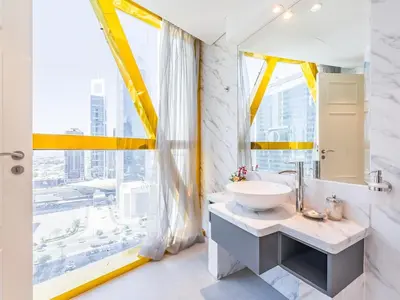 a bathroom with a sink and a large window at Luxury Spacious Condo in the Iconic Park Towers in Dubai
