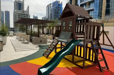 a playground with a slide and a play structure at Luxury Sea View Studio in Dubai Marina in Dubai