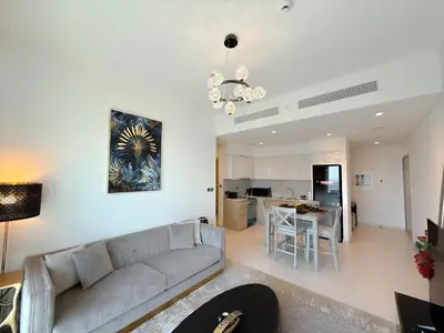 a living room with a couch and a kitchen at INA HOMES - Burj Royal 1 BR Stylish Apartment in Dubai