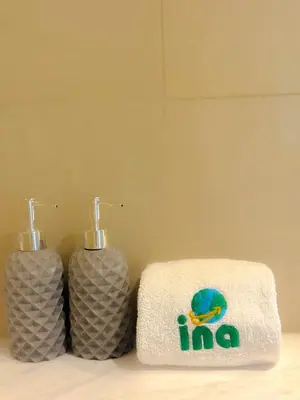 two towels sitting next to each other on a counter at INA HOMES - Burj Royal 1 BR Stylish Apartment in Dubai
