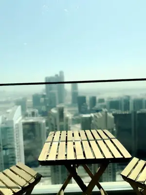 two wooden benches sitting on top of a building at INA HOMES - Burj Royal 1 BR Stylish Apartment in Dubai