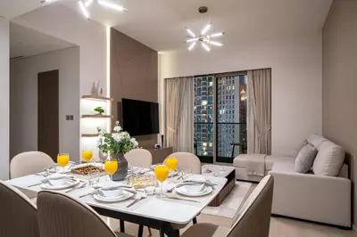a dining room with a table and chairs at Luxe Living at Grande Signature - Burj Khalifa and Sea Views - Brand New in Dubai