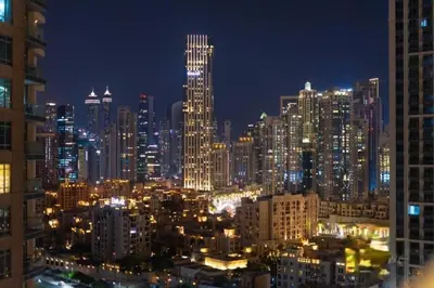 a view of a city at night with lights at Stylish Studio 5 min Walk to Mall & Burj Khalifa in Dubai