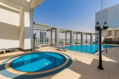 a swimming pool on the roof of a building at Stylish Studio 5 min Walk to Mall & Burj Khalifa in Dubai