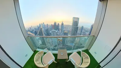 a room with two chairs and a view of the city at 60th High Floor - full World islands, Downtown and Ocean View - high quality Design and Furniture - 2 Bedroom in Dubai