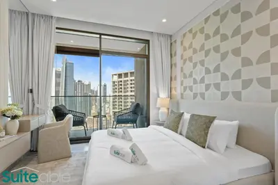 a bedroom with a white bed and a large window at Stunning 1 Bedroom with Burj Khalifa view in Dubai