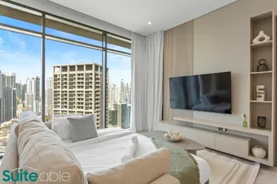 a living room with a couch and a large window at Stunning 1 Bedroom with Burj Khalifa view in Dubai