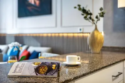 a book sitting on a counter with a cup of coffee at High floor Marina Views Walk to Beach JBR & Mall in Dubai