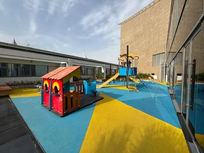 a playground with a slide and a play structure at ASHRI Stylish African-Inspired Studio in DIFC in Dubai