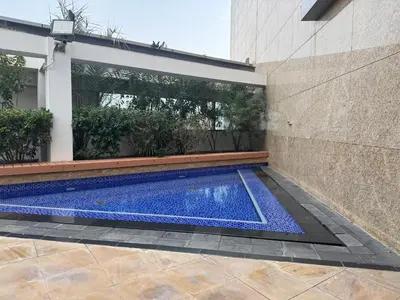 a swimming pool in the side of a building at ASHRI Stylish African-Inspired Studio in DIFC in Dubai