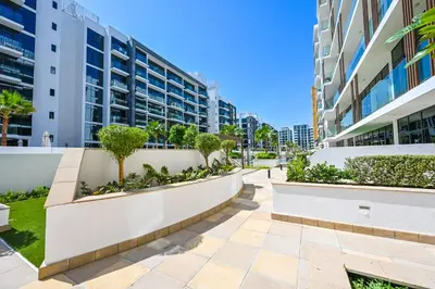 a walkway in front of a building at Cozy Studio with Balcony in Azizi Riviera and 10 Mins to Burj Khalifa in Dubai