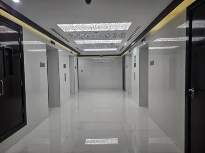 a hallway with white walls and a ceiling at Dubai Silicon Oasis Holiday Homes in Dubai