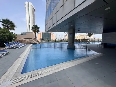 a swimming pool on the side of a building at Elegant 1BR in Ocean Heights in Dubai