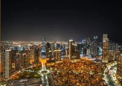 a night view of a large city at night at Luxury 3 BR Full Burj Khalifa and Fountain View in Dubai