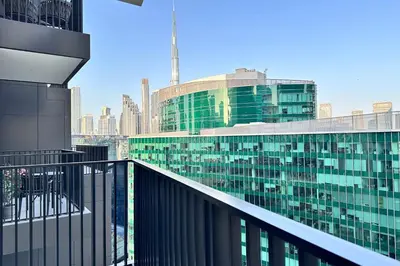 a view of a city from a balcony of a building at Vserve Modern Oasis Canal & Burj Views in Dubai