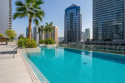 a swimming pool in the middle of a city with tall buildings at New Luxury 1BR Apart Business Bay with Balcony in Dubai