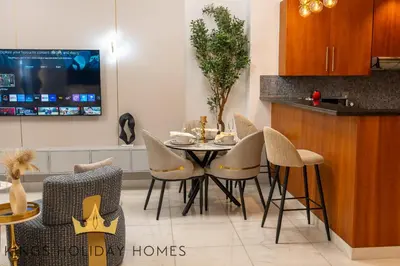 a dining room with a table and chairs at Central Park towers Difc suite kings in Dubai