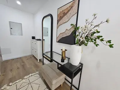 a living room with a table and a mirror at Marina Water Residence in Dubai