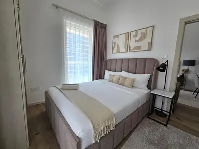 a bedroom with a large bed and a window at Marina Water Residence in Dubai