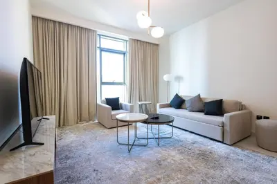 a living room with a couch and a table at Marina Vista - Elegant 1BR- 2606 in Dubai