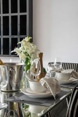 a table with plates and dishes on a glass table at Frank Porter - RBC Tower in Dubai