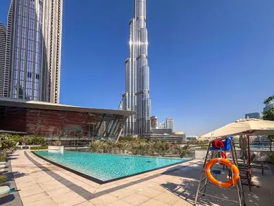 a swimming pool in the middle of a city with tall buildings at Frank Porter - Grande Signature in Dubai
