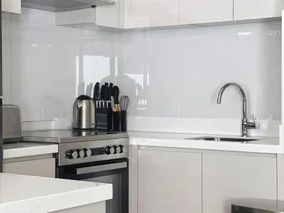 a white kitchen with a sink and a stove at 3 Bed - Aquilegia, Damac 2 in Dubai