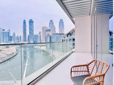 a balcony with a bench and a view of the city at Canal Front - Luxury 2BR Stay in Al Wasl in Dubai