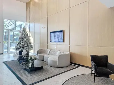a living room with a white couch and a christmas tree at One Residence - Retreat in Dubai