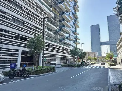 a motorcycle parked in front of a tall building at One Residence - Retreat in Dubai