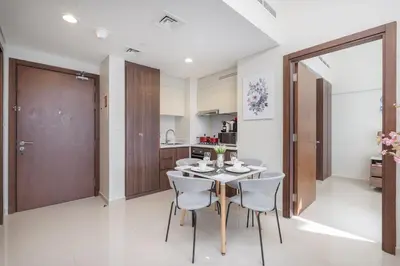 a kitchen and dining room with a table and chairs at Stunning Burj View - Cozy 2BR - 5 min Dubai Mall in Dubai