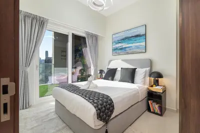 a bedroom with a large bed and a large window at Stunning Burj View - Cozy 2BR - 5 min Dubai Mall in Dubai