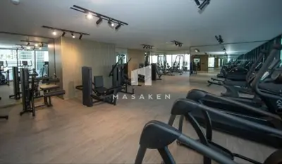 a gym with treadmills and machines in a room at Chic & Serene 1br Apt Balcony, Pool & Parking in Dubai