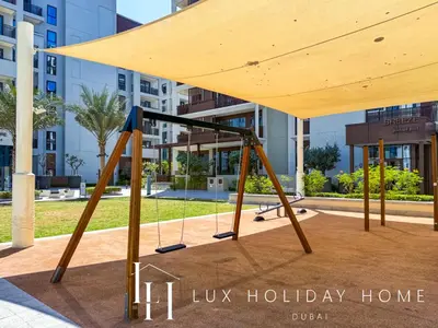 a swing set in front of a building at LUX The Dubai Creek Beach Suite in Dubai